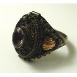 An early 20th century silver poison ring, the hinged lid set with oval amethyst,