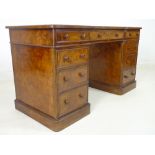 A Victorian burr walnut veneered twin pedestal breakfront desk,