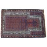 A Baluchi prayer rug, with dark blue ground, dark red patterned field, cream borders, 147 by 97cm.