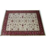 A modern Keshan rug, beige ground with scrolling foliate decoration, wide dark red border,