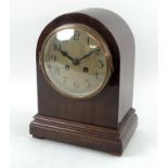 A 20th century mantle clock in domed mahogany case, eight day movement,