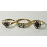 A 14ct gold ring set with three round cut high-set blue zircon brilliants,