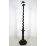 An early 20th century standard lamp with spiral column,