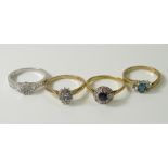 A collection of four rings comprising an 18ct gold Art Deco ring set with set with round cut