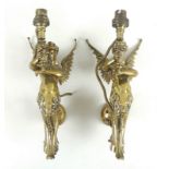 A pair of gilded brass sconces each in the form of a mermaid with angel wings bearing a torch,