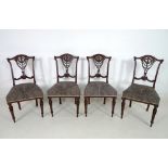 A set of four Victorian mahogany chairs, with pierced and foliate carved rails and backs,