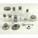 A collection of silver and glass dressing table jars, one with square glass body,