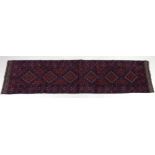 A Meshwani runner rug, with dark red and dark blue ground, six diamond pendants,