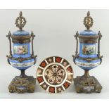 A late 19th century French part garniture, comprising two gilt bronze mounted vases,