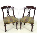 A pair of Victorian Aesthetic period mahogany dining chairs,