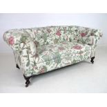 A Edwardian Chesterfield two seater settee, with scroll arms and back, sprung seat,