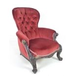 A Victorian walnut nursing armchair, with spoon back and padded arms,