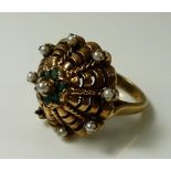 An unusual 9ct gold scalloped ring set with seed pearls and six emeralds, one pearl missing, size M,