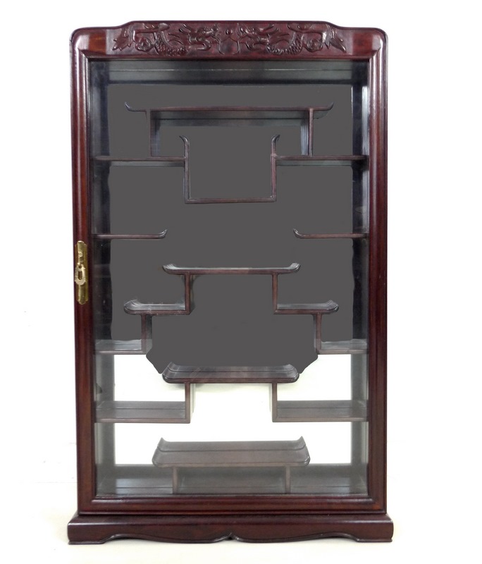 A modern Chinese hardwood display cabinet, carved with opposing dragons,