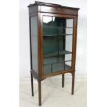 An Edwardian mahogany glazed display cabinet, shaped upstand,