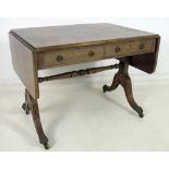 A Regency mahogany and brass inlaid sofa table, two frieze drawers with ring handles,