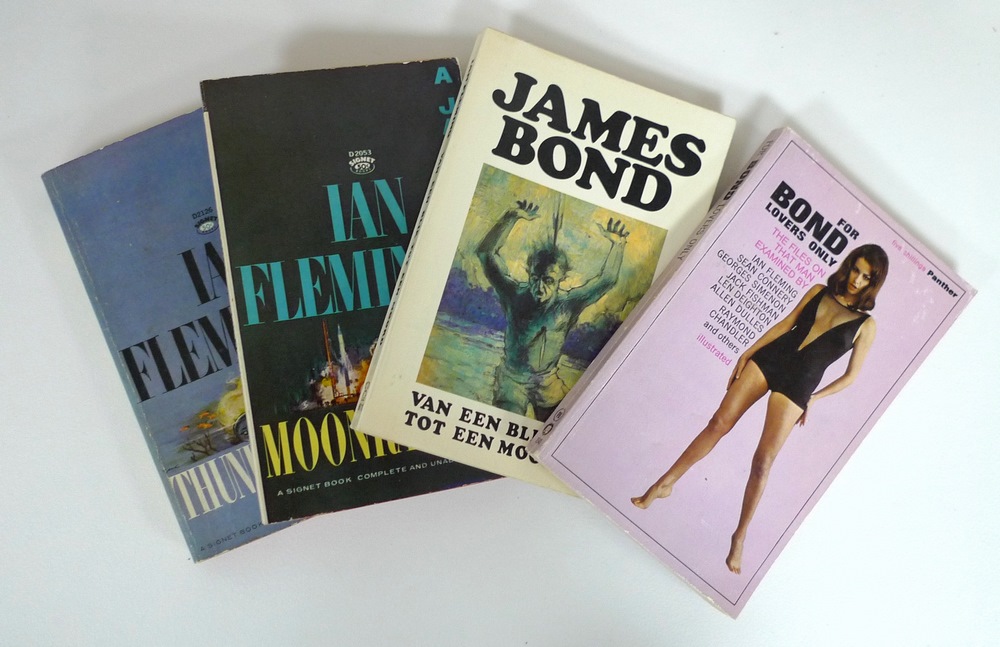 A collection of James Bond paperbacks, including editions by Signet New American Library,