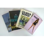 A collection of James Bond paperbacks, including editions by Signet New American Library,