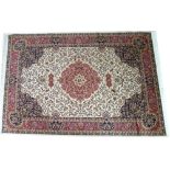 A modern Keshan rug with beige ground, dark blue corners, red medallion and multiple borders,