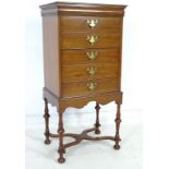 A reproduction mahogany veneered music cabinet, in William and Mary style,