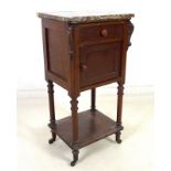 A 19th century French stained mahogany pot cupboard, with red marble surface, carved corbels,