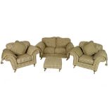 A modern three piece suite, comprising two seater sofa, two armchairs and footstool,