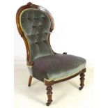 A Victorian mahogany nursing chair, circa 1890, with carved and moulded rail, rosette motifs,