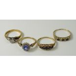 A collection of four rings, each hallmarked to the bands,