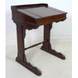 A Victorian mahogany scribe's or school desk, lift lid to the slope, three quarter gallery behind,