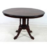 A late Victorian oval occasional table, with marquetry inlaid top decorated with urns and scrolls,