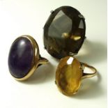 A collection of rings, comprising a 9ct gold ring with large oval purple stone cabochon,