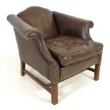 A modern brown leather armchair, in the Georgian style, with arched back and scroll over arms,