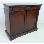 An early 19th century mahogany chiffonier, frieze drawer with carved rosettes to each end,