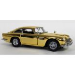 A 1/24 scale 22 carat gold plated die cast and ABS plastic replica model Aston Martin DB5,