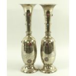 A pair of Arts and Crafts brass vases, set with turquoise and red hardstone cabochons,