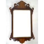 A 19th century fretwork mirror, the gilt slip with incuse corners, 92 by 53.5cm.