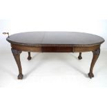 An Edwardian mahogany extending dining table, circa 1900, carved with gadrooned edge,