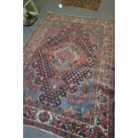 A Bakhtiari rug, Persian, the indigo field with a bold madder medallion,