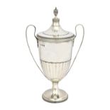 A silver twin handled trophy cup and cover, of Adam style,