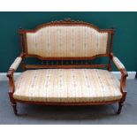 A late 19th century walnut show frame sofa, with ribbon carved crest and bow seat,