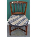 A Regency mahogany dining chair on tapering square supports,