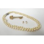 A two row necklace of uniform cultured pearls, on a white gold and cultured pearl clasp,