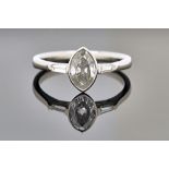 A platinum and diamond ring, mounted with the principal marquise shaped diamond at the centre,