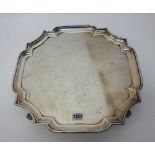 A silver salver, of shaped square form, with a pie-crust rim, in the Chippendale style,