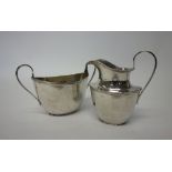 A Scottish silver twin handled sugar bowl with a matching milk jug, each piece of oval form,