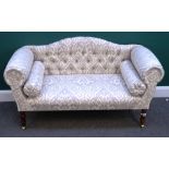 A modern small hump back sofa with roll over arms on turned supports, 140cm wide x 77cm high.