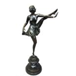 A modern bronze female dancer, modelled left leg raised,