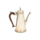 A silver coffee pot, in a tapering cylindrical design, on a circular foot,