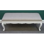 A 19th century style rectangular footstool, with white painted floral capped scroll supports,