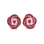 A pair of gold, ruby and diamond set earclips, each in a spiral design,